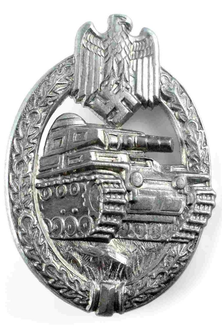 WWII GERMAN ARMY SILVER PANZER TANK ASSAULT BADGE: WWII German Army Silver Panzer Tank Assault Badge. The front shows a tank in the center with a German army eagle clutching a swastika at the top. All three are surrounded by an oval oak leaf wreath. M