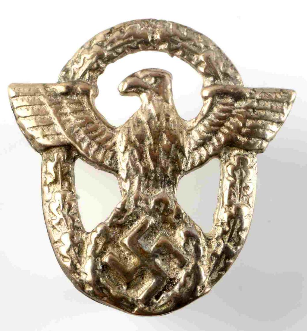 WWII GERMAN THIRD REICH POLICE BAYONET EAGLE: German World War II Police Dress Bayonet Grip Eagle Emblem. Measures 3/4" wide by 3/4" tall. The front shows a German police eagle clutching a swastika in his talons. Both are surrounded by an oval oa