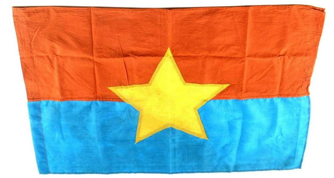 VIETNAM ERA VIET CONG VC COMBAT BATTLE FLAG: Vietnam Era Viet Cong VC Combat Battle Flag. Measures 29 1/2" wide by 21" tall. Has a five armed cloth yellow star in the center of the flag. Double sided. Three piece machine sewn blue, orange and ye