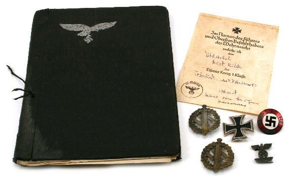 MIXED LOT OF THIRD REICH BADGES: A good lot to include: A "Sieg Heil" NSDAP party badge, two sports badges, both maker marked, a 1939 Iron cross, 1st class, spange badge, together with an Iron cross 1st Class with issue type certific