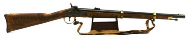 BLACK POWDER PERCUSSION .54 CAL CARBINE: Italian made. 23 inch round barrel, minor rust spots. Some light wear. Brass fittings, wood stock has been cleaned overall and has tacks hammered in to form "SLA". About 80% overall. Very good.
