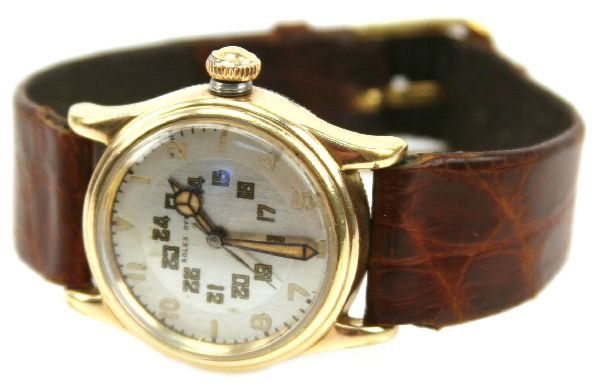 VINTAGE ROLEX OYSTER WITH 14K GOLD CLAD CASE: 30mm circular, gold clad yellow gold bezel. 24 hour face model. Properly marked. Slightly curved crystal. 16mm leather band.