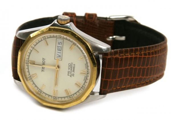 VINTAGE TISSOT PR100 WRISTWATCH: 30mm circular, gold rimmed bezel and 14k stamped to the back. White dial with black numerals. Slightly curved crystal. 17mm B&M leather band.