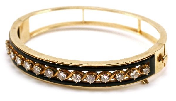 LADIES 14K YELLOW GOLD DIAMOND BANGLE BRACELET: Unique ladies 14K yellow gold bangle bracelet. Featuring 14 sparkling diamonds, totaling 3 carats. Diamonds range in size from 3-4mm each. Lever lock safety clasp with security chain. Top of bracelet 