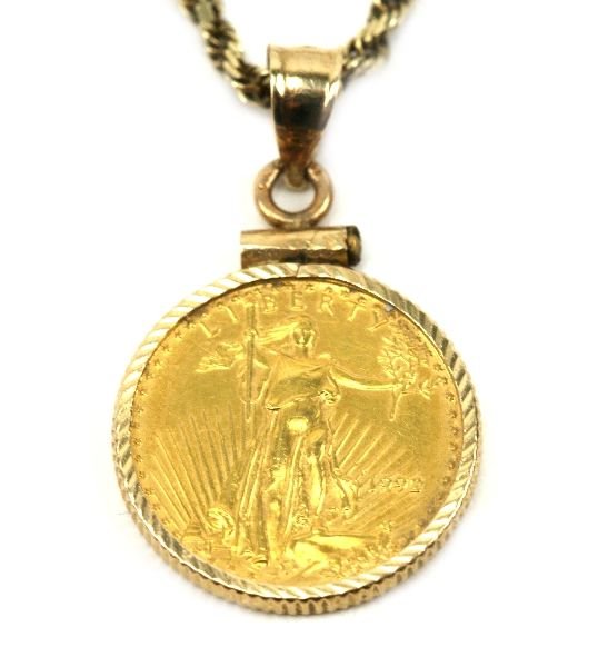 14K YELLOW GOLD NECKLACE WITH 24K GOLD EAGLE: Unisex 14K yellow gold diamond cut rope necklace with 1/10 ounce gold eagle coin made of pure 24K gold. Necklace is 22inches in length, weighing 11.8 grams.