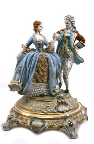 LARGE DRESDEN CENTERPIECE STATUE BY KAISER: Large romantic statuary standing approximately 19 inches. Hand painted and edged with gilding and silvering. Classical design. KAISER mark (Crown with AK and Germany). Possibly some slight damage to t