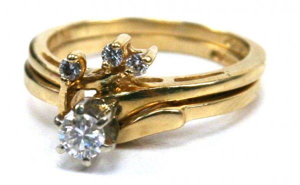 LADIES 14K GOLD SOLITAIRE DIAMOND RING W/ ENHANCER: Beautiful ladies 14K yellow gold solitaire diamond ring, composed of an approximate 3/16 carat prong set solitaire diamond, along with 2 - 1/32 round accent diamonds. Together with a 14K yellow gold e