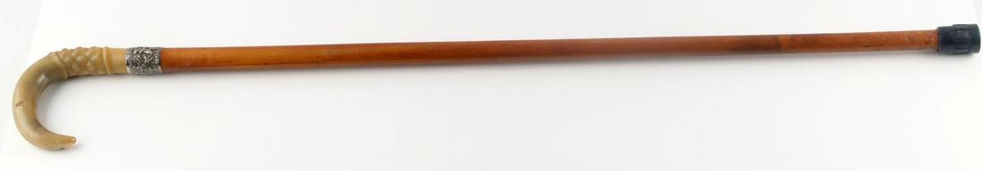 ANTIQUE WOODEN CANE WALKING STICK HORN GRIP: Curved horn grip, engraved and monogrammed silver plate collar, wooden staff, rubber ferrule. Measures 36 inches long. Good condition.