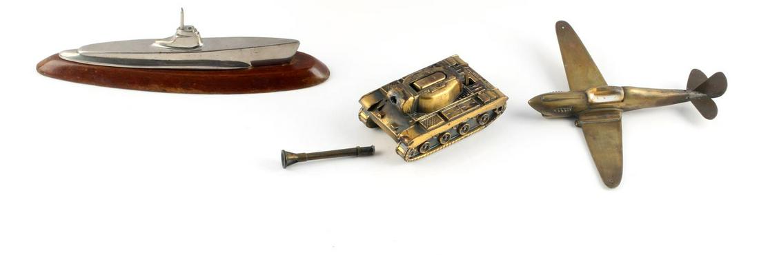WWI WWII TRENCH ART SPITFIRE PLANE TANK SUBMARINE: Lot includes submarine desk ornament (3x9 inches), a small tank lighter (6x2 3/8 inches), and a small fighter Spitfire plane (6 1/2x7 inches). Very good condition.