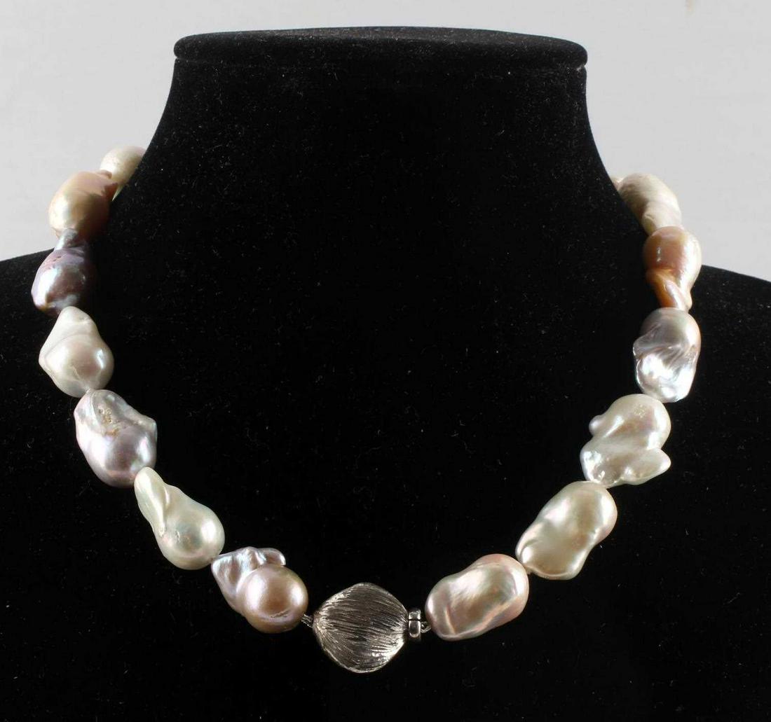 LARGE BAROQUE PEARL STERLING SILVER NECKLACE: Baroque pearl necklace. Pearls measurements range 23- 29mm with cream, rose, lavender and peach toning . Necklace measures 16 inches. Nice sterling clasp.