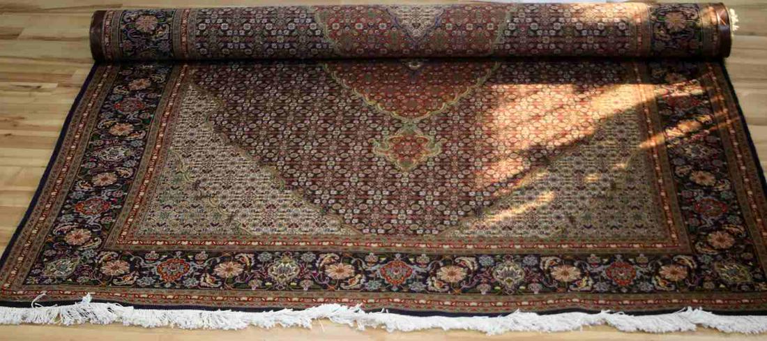 VINTAGE TABRIZ WOOL RUG W HERATI MEDALLION: 80X120 inch (measurement includes fringe) hand knotted vintage 1970's Tabriz area rug with Herati pattern and medallion, multi color burnt red and navy fields. In very good condition. For local pick u