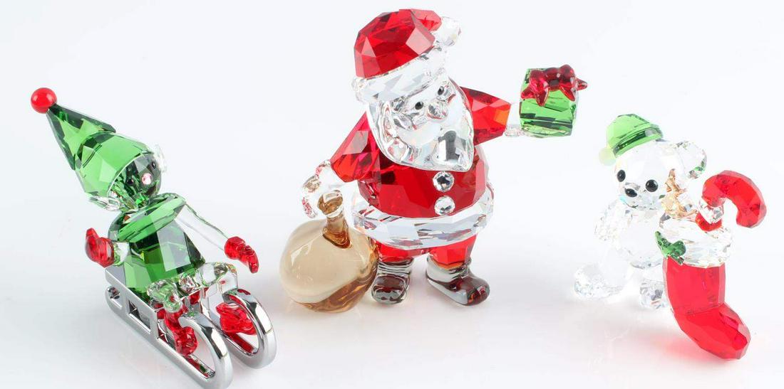 3 SWAROVSKI XMAS ELF SANTA & TEDDY BEAR FIGURE LOT: Lot of 3 official Swarovski crystal Christmas figures. Santa figure has had a repair to ball on his hat. All measure between 4 and 7 centimeters in height.