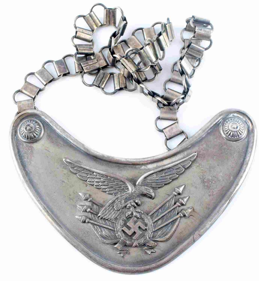 WWII GERMAN LUFTWAFFE STANDARD BEARERS GORGET: WWII German Luftwaffe standard bearers gorget with chain. Luftwaffe eagle to center. Non Fluorescing Black wool backing with two hooks with center one marked "ASSMANN". Measures 180mm X 140mm and chai