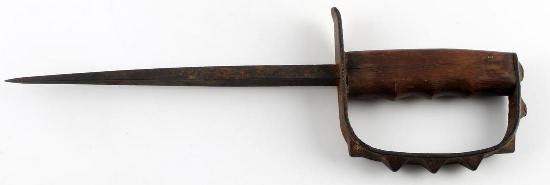 WWI US MILITARY LF&C MODEL 1917 TRENCH KNIFE: Triangular blade measures 8 7/8 inches, spiked steel D-grip, finger hold wooden grip, maker marked to top of guard, however, illegible. Suggs hand-carved into wood. Heavy pitting and rust. Two minor c