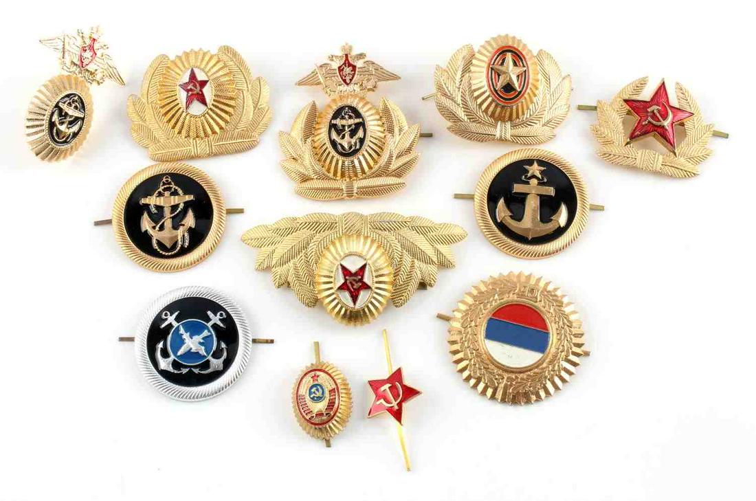 GROUP OF 12 ORIGINAL SOVIET RUSSIAN HAT BADGES: Group of 12 various original Soviet Russian hat badges. Largest badge measures 3.5 X 2 inches, smallest measures 1 X 1.5 inches. Very good condition on all of these badges. Unauthenticated; sold as is