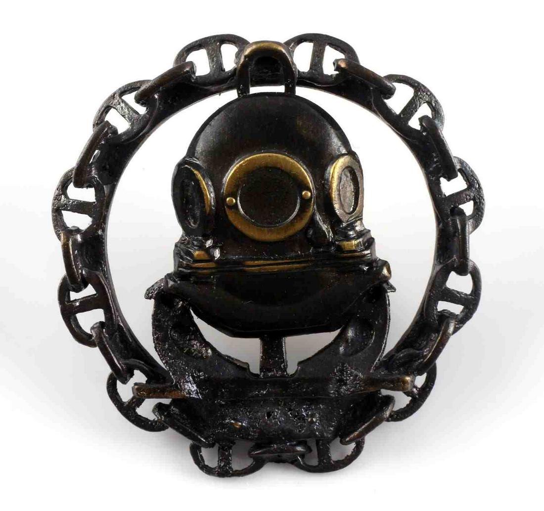 WWI IMPERIAL RUSSIAN BRONZE DIVER GRADUATE BADGE: WWI Imperial Russian bronze deep diver naval graduate badge. Diver helmet to center with chain surrounding and anchor in background. Screwback. 1 1/2 inch diameter. Unauthenticated, sold as is.0