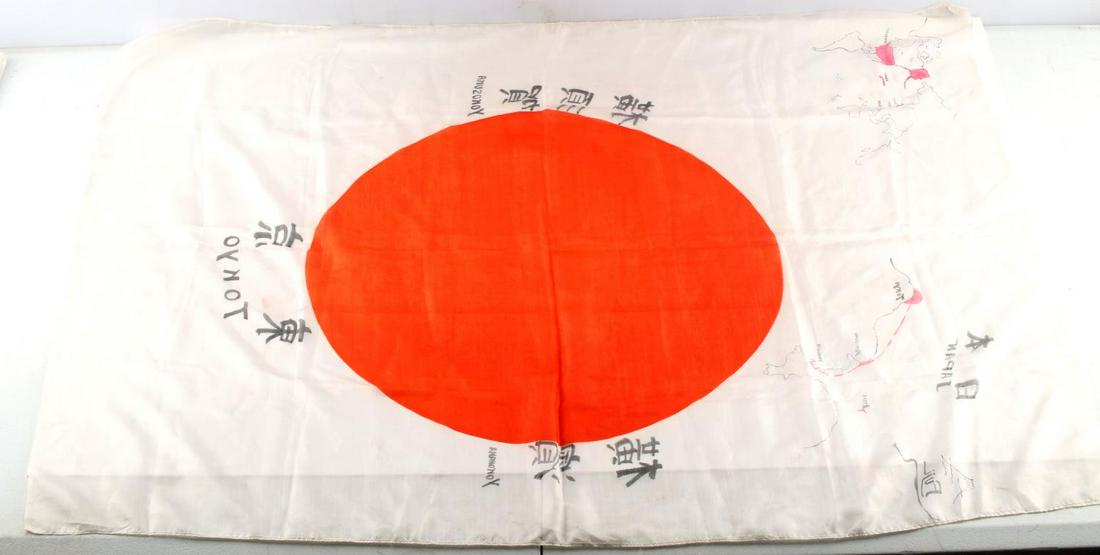 WWII JAPANESE AMERICAN COMMEMORATIVE SILK FLAG: WWII Japanese-American commemorative silk flag. Features sketches of both Japan and American (Hawaii) and the flag of Japan surrounded by city names. Measures 36 X 26 inches. Does not fluoresce under 
