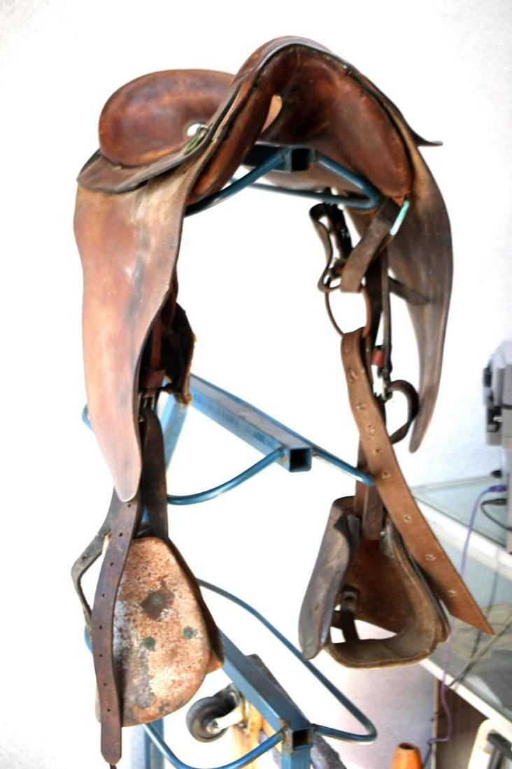 US INDIAN WARS MCCLELLAN SADDLE WITH STIRRUPS: U.S. Indian wars McClellan leather saddle with hooded stirrups, saddle in good condition with billet straps and buckles in place, as well as skirt and fenders. No markings are present on saddle, some 