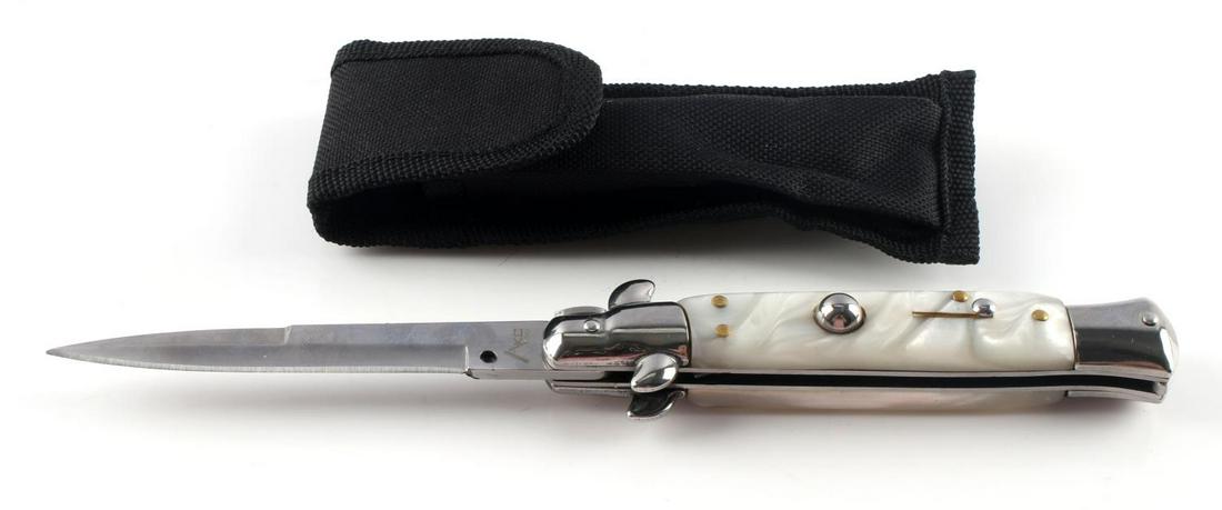 ITALIAN MADE AKC SWITCHBLADE KNIFE MOTHER PEARL: AKC switchblade knife with mother of pearl grips with soft case. 9 inches long. Very fine condition.