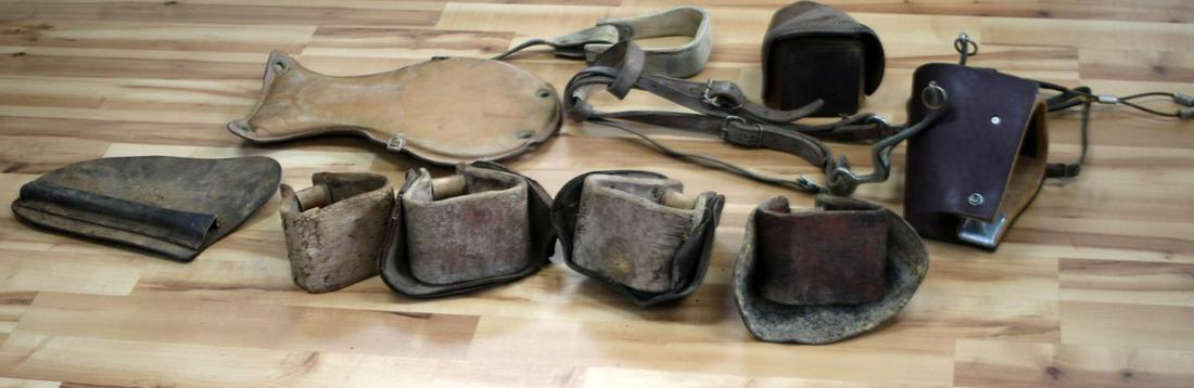 LOT OF EQUESTRIAN SADDLE GEAR HOODED STIRRUPS: Lot of equestrian saddle gear including 5 assorted stirrups, 4 hooded; a saddle cushion, and a bridle with a bit. Some in worn condition.