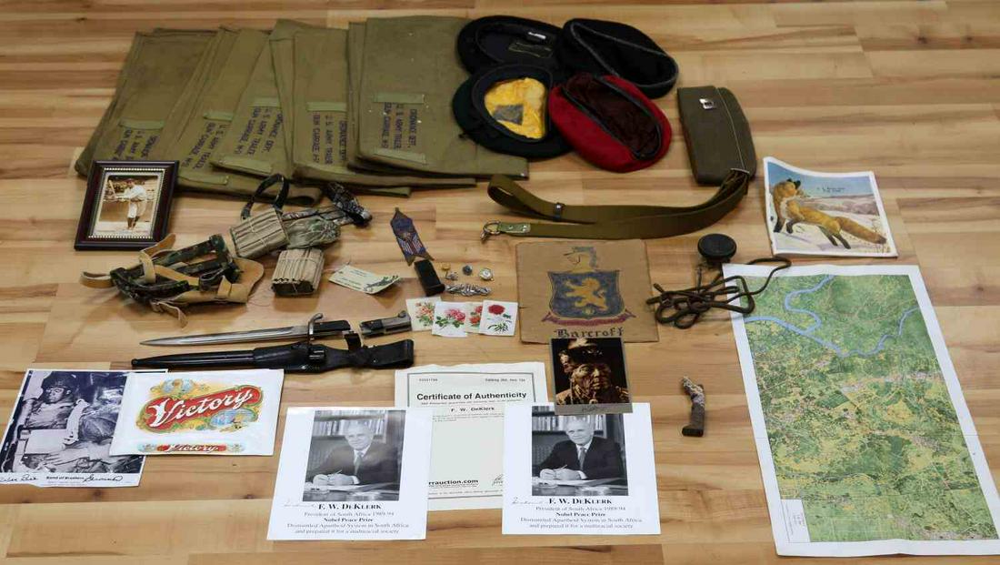 WWI WWII MILITARY MULTI CONFLICT COLLECTABLE LOT: Partial listing includes, damaged K-98 bayonet, Jeep Tool cloths, Band of Brothers Wild Bill Guarner autograph, WWII overseas cap with sterling Captains bars, 1918 WWII radio earpiece, Berets, archery