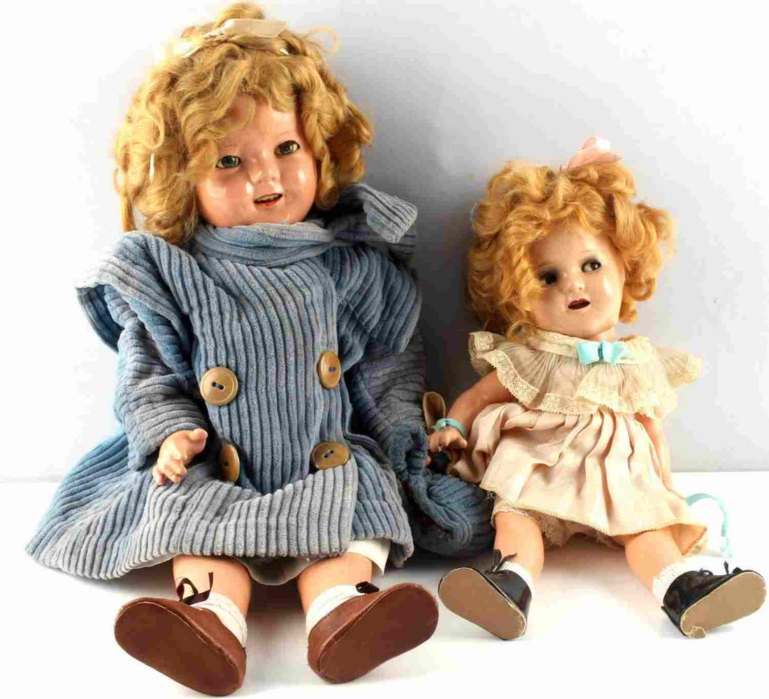SHIRLEY TEMPLE 1930S IDEAL COMPOSITION DOLL: Vintage 1930s Shirley Temple composition doll by Ideal Toy Co. One stands 13 inches tall the other 18 inches. Marked on back and neck. Original tagged dress, shoes and undergarments.