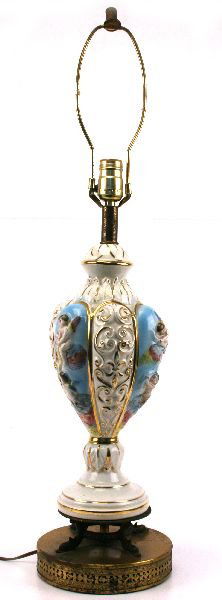 CAPODIMONTE BLUE CHERUB CERAMIC TABLE LAMP: A 31 inch fantastic Italian Capodimonte hand painted table lamp featuring cherub relief figures with gold fligree embellishments. Base of lamp is brass with dolphin feet. Lamp is in good condition wit