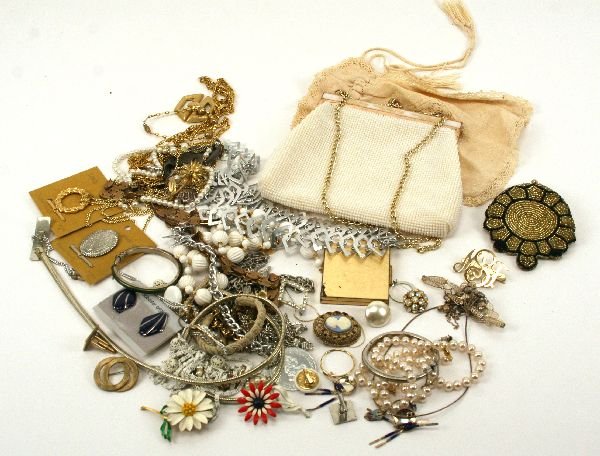 LARGE COSTUME & STERLING JEWELRY LOT: Lot of mostly costume jewelry with a few select pieces of sterling silver. Lot includes: earrings, pins, necklaces and pendants, bracelets, cuff links, and beaded purses.