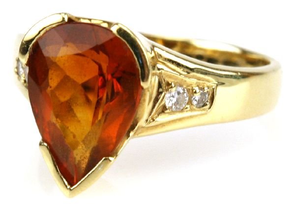 H STERN 18K GOLD ORANGE TOURMALINE & DIAMOND RING: An H. Stern collection 18K yellow gold ladies ring with a large orange tourmaline center stone and 2 small diamonds on each side. Size 7. Weighs 4.9 grams.