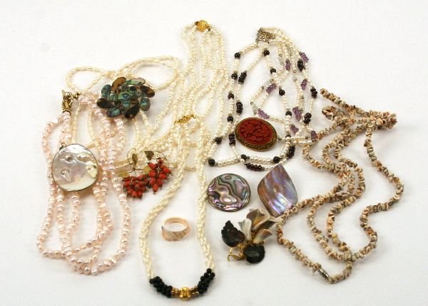 CORAL SHELL MOTHER OF PEARL & STERLING JEWELRY LOT: Lot features several cultured pearl costume jewelry necklaces, a ladies size 8 1/2 carved shell ring depicting a dove, a mother of pearl pendant, a sterling silver and abalone pendant, a shell flower 