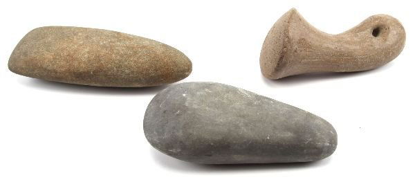 2 CELTS & AN UNUSUAL HOLED PESTLE: 2 CELTS & AN UNUSUAL HOLED PESTLE A nice pair of celts or smooth axe blades one of greenstone and another of granite, also an unusual holed handle pestle with a polished and curved handle, this piece