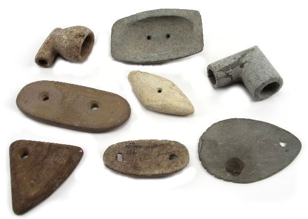 COLLECTION OF GORGETS AND PIPES: COLLECTION OF GORGETS AND PIPES A grouping of gorgets pendants and pipes as follows, a single hold limestone gorget provenanced to Williston Fl., a pipe and 2 hole gorget of granitite material from Ec