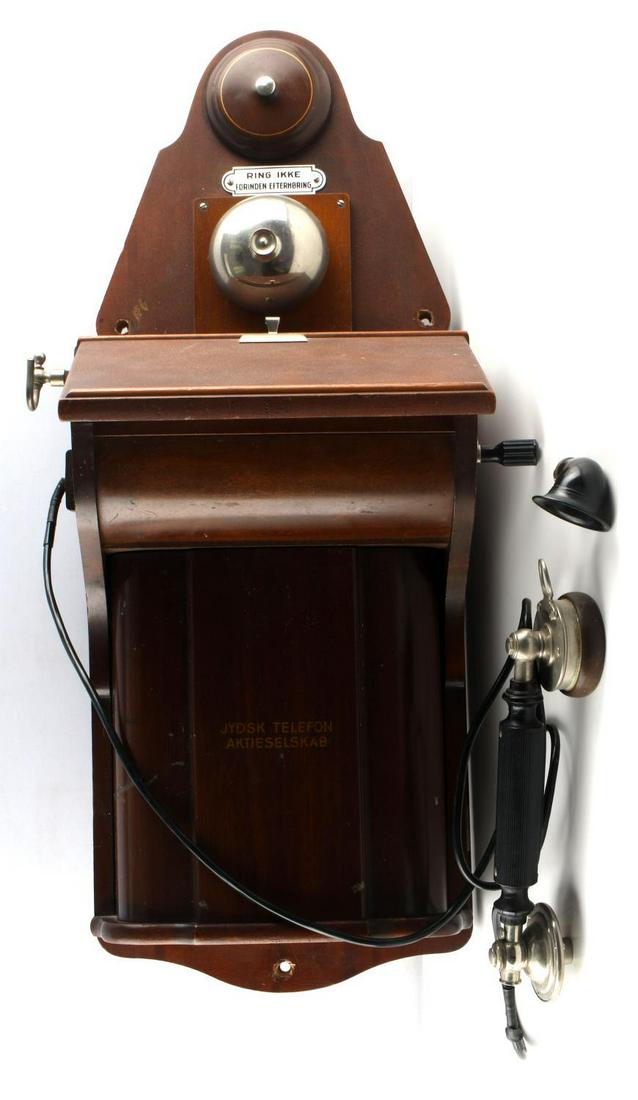 DANISH ANTIQUE FIDDLEBACK WALL CRANK PHONE JYDSK: Antique fiddleback crank phone with metal and bakelite receiver and mouth piece. The phone box measures 26 7/8 x 10 1/4 inches. Receiver measures 10 1/2 inches. Minor paint loss and dents. Has a 4 inc