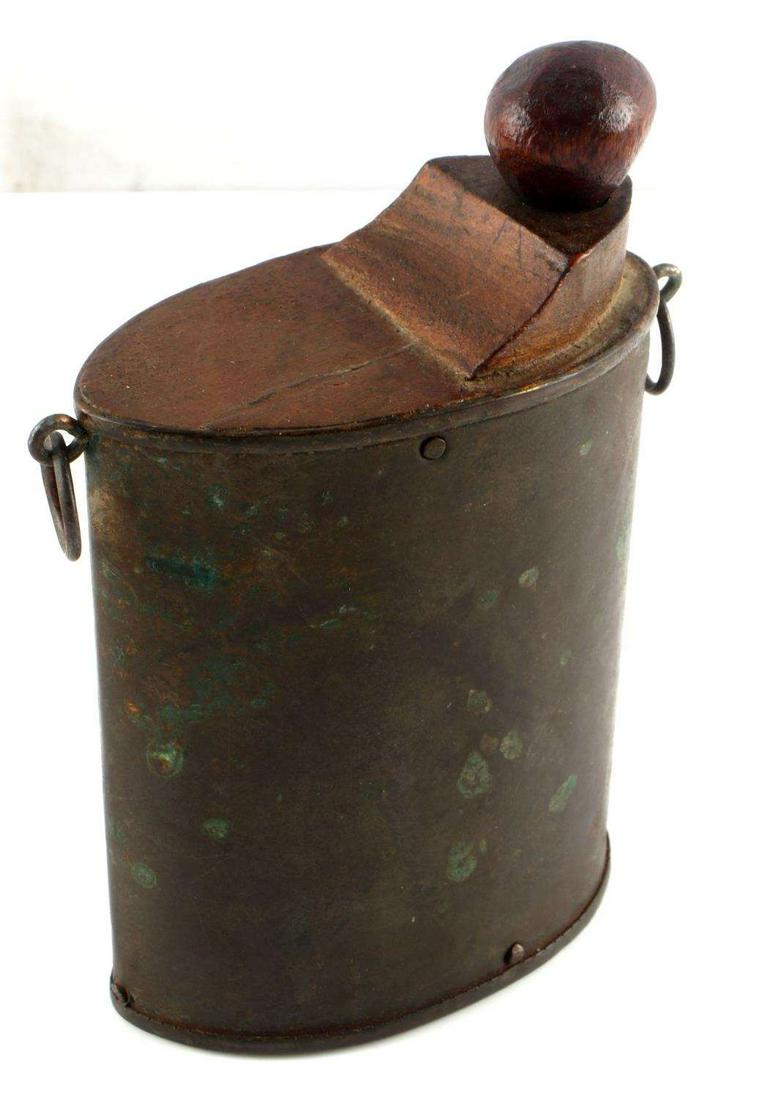 ANTIQUE TIN & WOOD POWDER FLASK 5.5 INCH: Tin body, wood fittings and knob on top. Two loops for attaching. 5.5 inches tall. Very good condition.