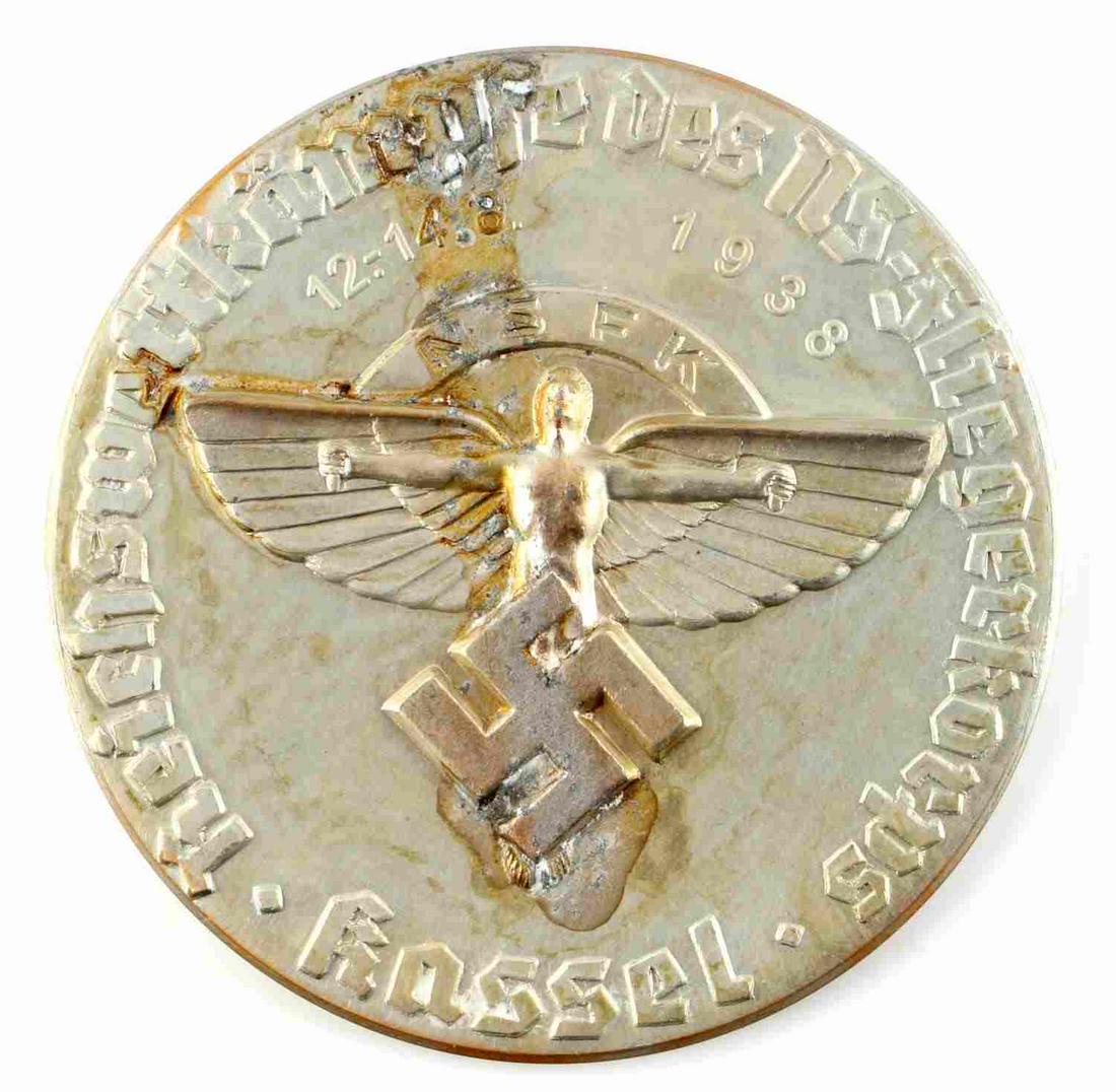 WWII GERMAN 1938 NSFK GLIDER KORPS TABLE MEDALLION: German WWII 1938 NSFK Glider Korps Table Medallion. Measures 3 3/16” in diameter. The front reads ‘Reichswettkampfe des NS-Floegerkorps Kassel 12.-14.8 1938 NSFK’. Shows the Icarus winged man in