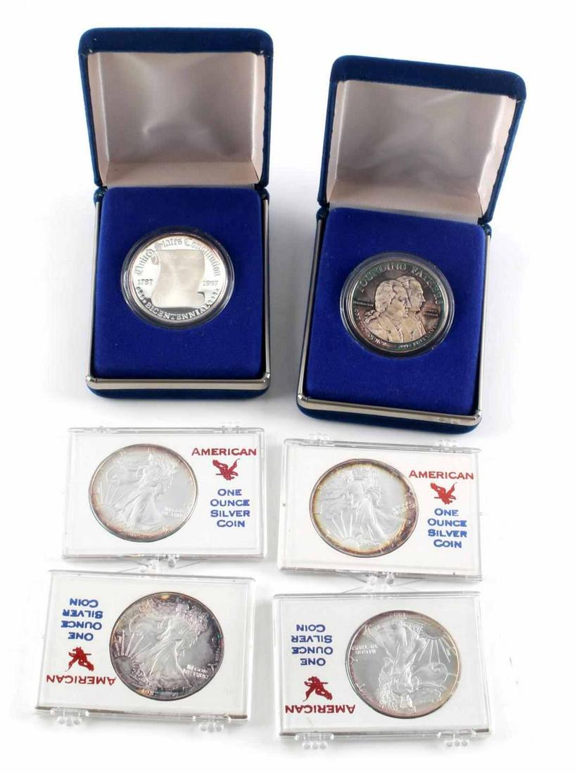 6 SILVER COINS AMERICAN EAGLES & FOUNDING FATHERS: Lot of 6 fine silver coins: 4 American Silver Eagles (2)1987, (2)1992 and 2 Bicentennial Founding Fathers 1 oz. silver coins in boxes as issued by the mint. One with unusual case toning.