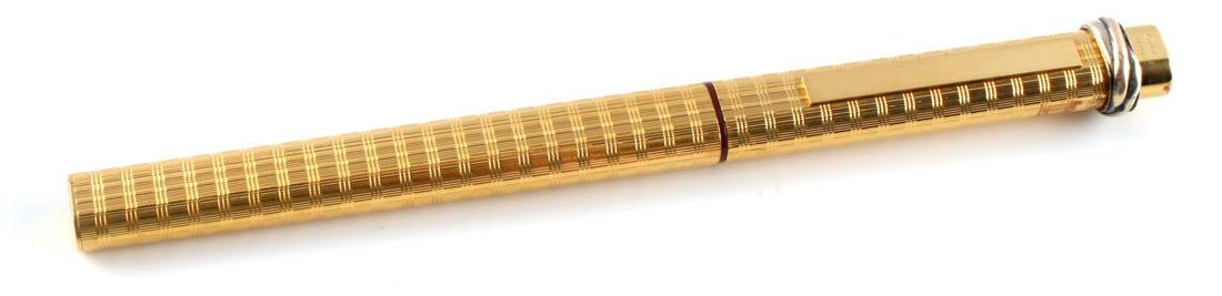 CARTIER PARIS GOLD PLATED INK PEN: Cartier Paris designer gold plated roller ball ink pen, serial number 429027. with grid pattern and tri color wrap. In good condition with light wear.