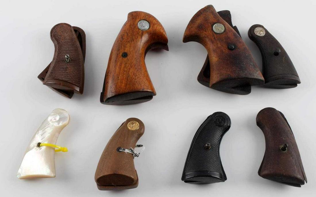 COLT SINGLE ACTION REVOLVER PISTOL GRIPS LOT OF 7: Includes 4 wood, 3 plastic and one mother of pearl, measuring along the curve 3 1/4 to 4 1/4.