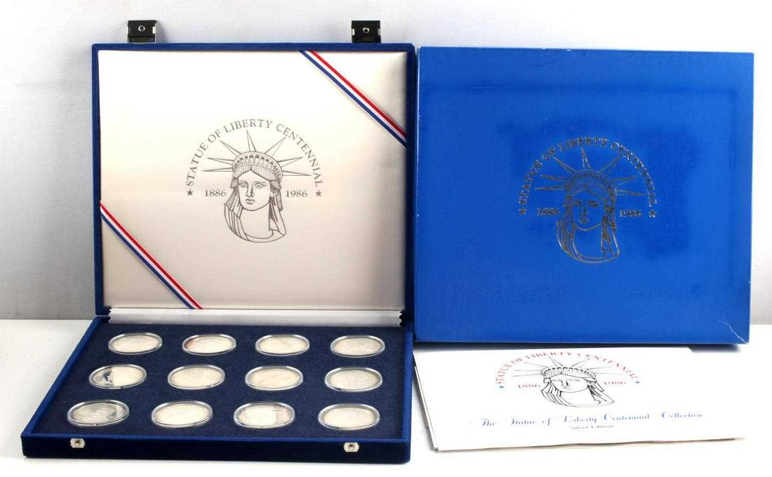 STATUE OF LIBERTY CENTENNIAL 12 SILVER COIN SET: Includes .90 silver 26.73 gram Liberty silver dollar from the U.S. Mint, and 11 silver medals of .925 silver fineness and a weight of 28.35 grams.