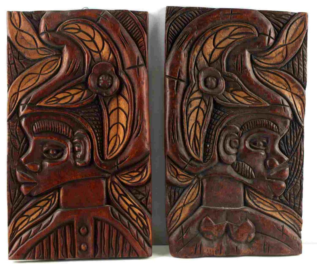 PAIR OF HANDCARVED POLYNESIAN WOOD WALL HANGINGS: Male and female bust depicted in relief, hanger to back. Each measures 15.5 X 9 inches. Very good condition.