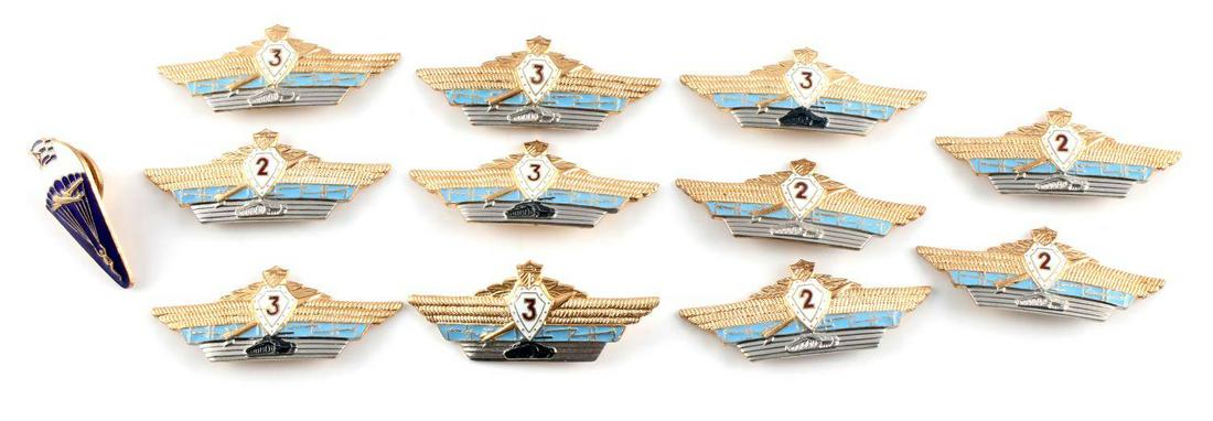 12 COMMUNIST CUBAN TANK PARACHUTE BADGES: 12 assorted Communist Cuban military badges. Cuban parachuting, Cuban 2nd and 3rd brigade tank badges. Unauthenticated, sold as is.