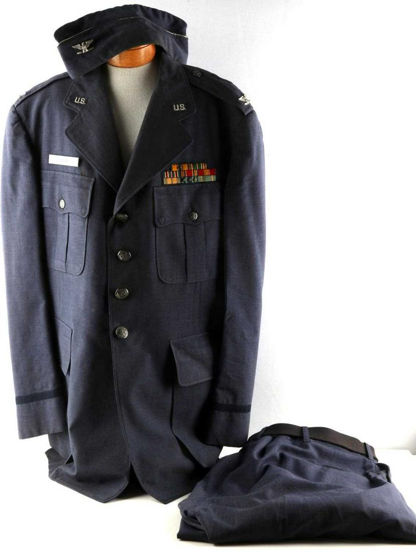 US AIR FORCE NAMED TROPICAL BLUE SHADE UNIFORM: US Air Force named tropical blue shade dress coat measuring at a 44R. Coat features colonel insignia, and features medals from the WWII European theatre, Vietnam, Korea, and an air medal. Features all
