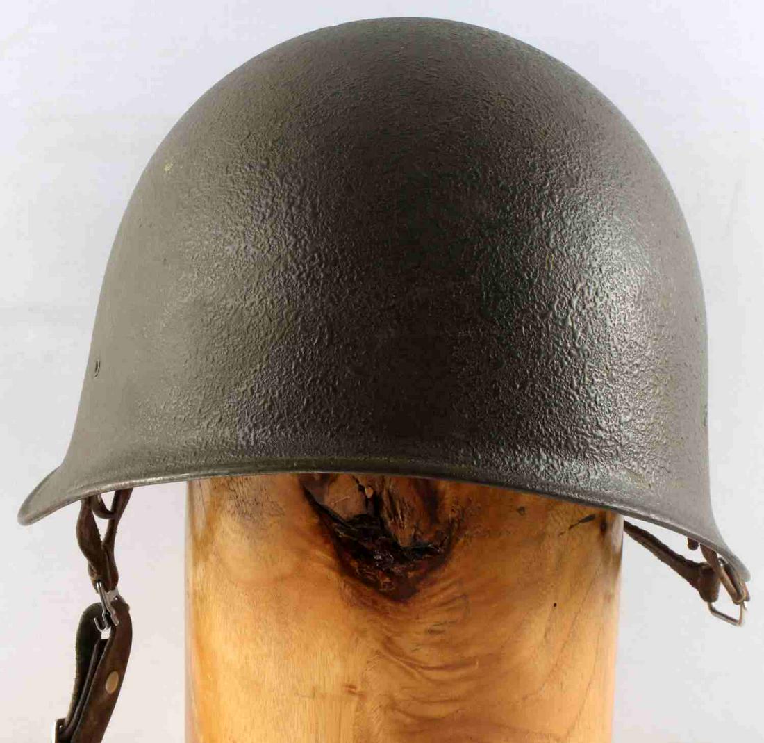 WWII SWISS MADE PARATROOPER HELMET W LEATHER: A WWII Swiss paratrooper helmet. Leather interior with 4 tongues. Stamped 57-58 on interior aluminum lining. Measures 9 1/4 x 6 3/4 inches. Very good condition.