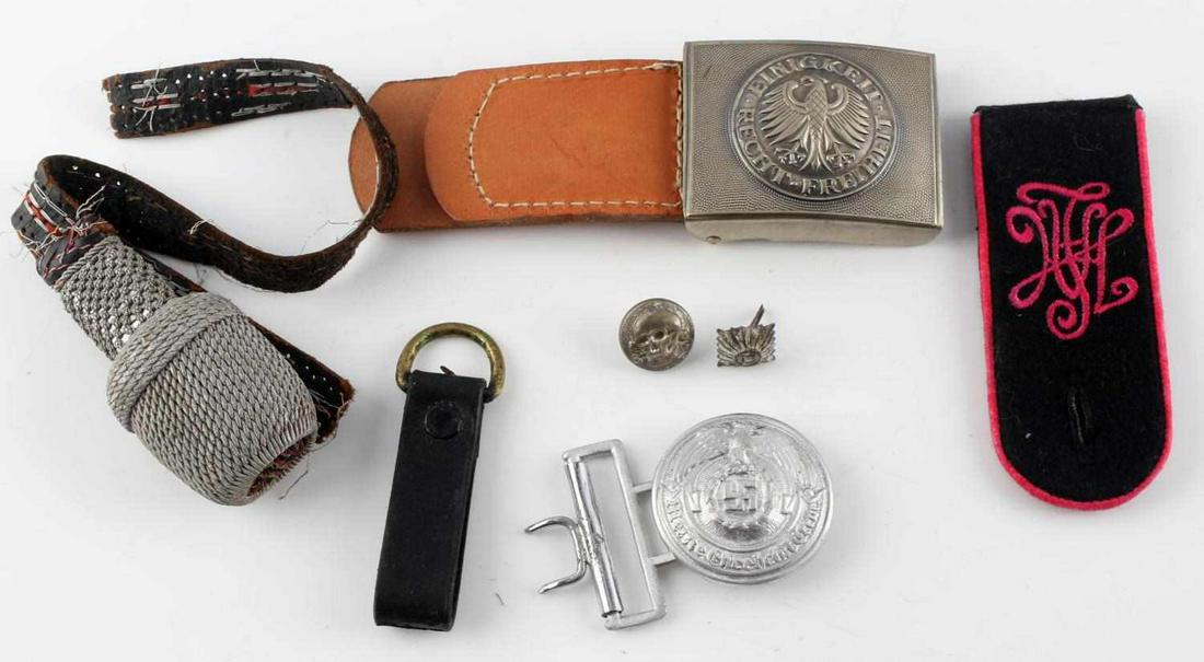 WWII THIRD REICH GERMAN BELT BUCKLE INSIGNIA LOT: Lot includes: aluminum buckle, nickel steel buckle with leather part, leather keychain, one shoulder board with pink piping, totenkopf button, cap pin, and torn portepee. Condition varies.