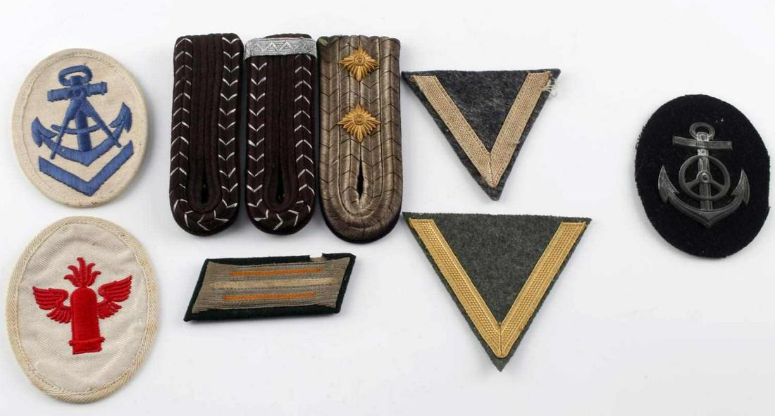 WWII GERMAN ASSORTED PATCH & SHOULDER BOARD LOT: Lot of 9 assorted WWII German patches and shoulder boards. Two Kriegsmarine patches, anti-aircraft patch, two army enlisted chevrons, one set of shoulder boards, one collar tab, and one additional sho