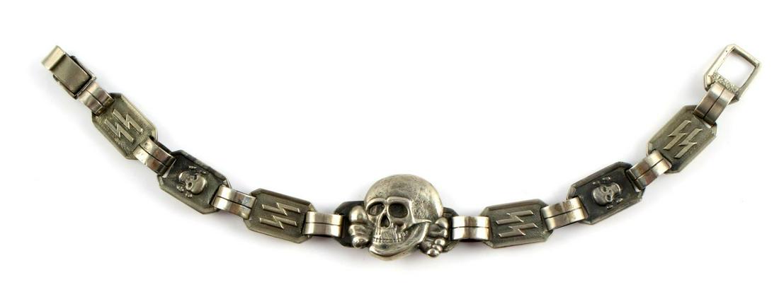 GERMAN WWII THIRD REICH WAFFEN SS BRACELET: German SS bracelet with alternating totenkopf and SS sig rune links and larger totenkopf center. Several hallmarks present on reverse. Measures 9.25" in length. Very good condition overall. Unauthenti