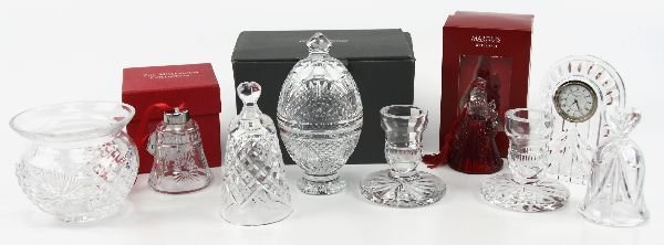 WATERFORD CRYSTAL LOT CLOCK CHRISTMAS & MORE: 69001 WATERFORD CRYSTAL LOT CLOCK CHRISTMAS & MORE An 8 piece grouping of Waterford crystal to include a pair of candle sticks, Marquis Santa bell boxed, 7 inch egg boxed, overture small clock, votive