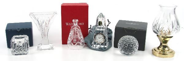 WATERFORD CRYSTAL LOT: 69005 WATERFORD CRYSTAL LOT A lot containing an obelisk clock measuring 6 inches tall, a petite flute vase (6 inches tall), a 1989 Christmas bell (boxed), and a Millenium (2000) Times Square Ball pape