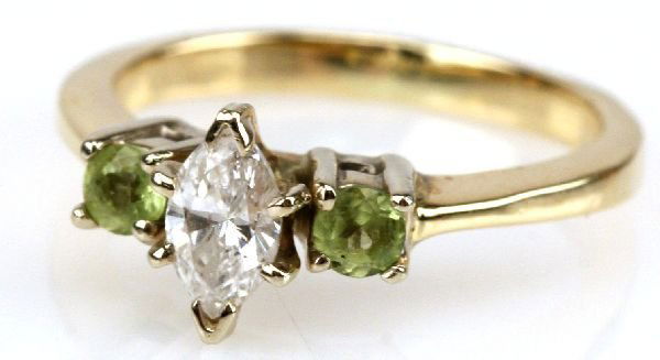 1/3 CT MARQUISE DIAMOND RING 14K GOLD: 69160a 1/3 CT MARQUISE DIAMOND RING 14K GOLD A stunning ladies 14K yellow gold ring featuring a 1/3 ct marquise shaped diamond along with 2 1/16 ct peridots. Diamond is approximately SI-1 to SI-2 clar