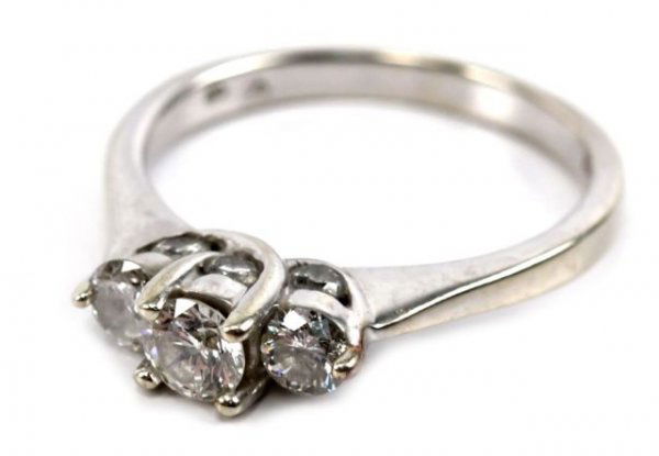 14K WHITE GOLD 3 STONE DIAMOND RING: A ladies 14K white gold diamond ring. 1/4 ct diamond with 2 1/6 ct diamonds. 3 smaller diamonds on each side. 9 diamonds total, approximately 1/2 ctw. Size 7. Weighs 3.8 g.